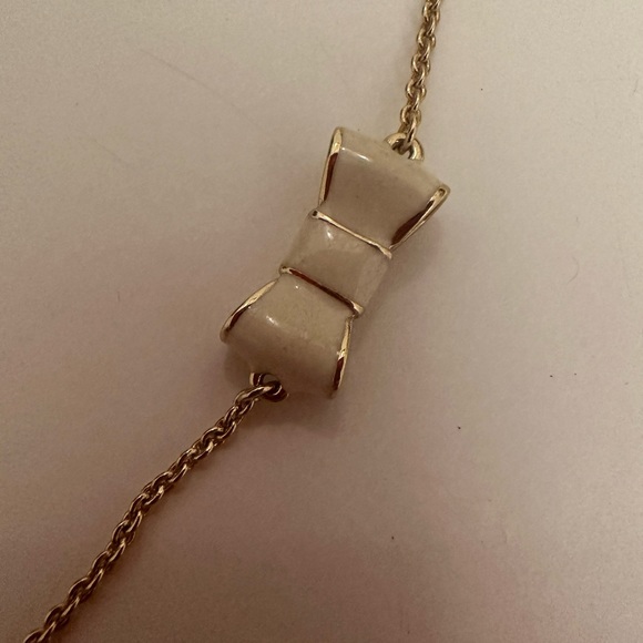 Kate Spade New York Take a Bow Gold and White Enamel Bow Scatter Chain Necklace - Picture 8 of 9
